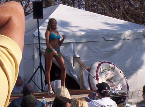 1986 Ford Bronco - A woman participates in a bikini contest held outdoors under a large tent.