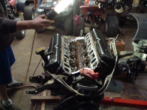 1989 Ford Crown Victoria LTD - V8 engine with valve covers removed, being worked on in a garage setting.