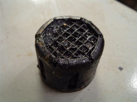 1989 Ford Crown Victoria LTD - This is a close-up of a used oil filter screen, likely removed during engine maintenance.