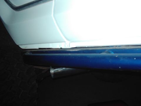 1978 Ford Bronco - Side step and exhaust pipe detail on a vehicle.
