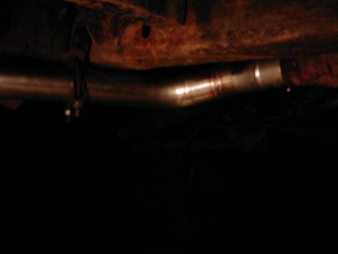 1978 Ford Bronco - Underside view of a vehicle's exhaust pipe system, showing a metal section and clamp.
