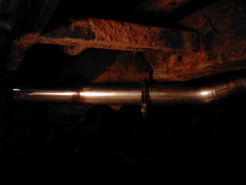 1978 Ford Bronco - Close-up of an exhaust pipe and heavily rusted frame components, with a Supermotors.net watermark.