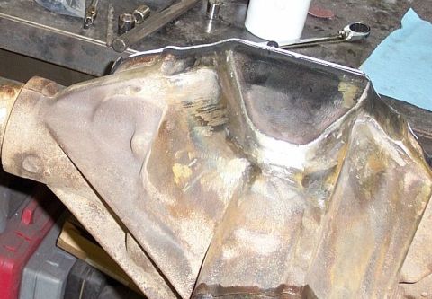 1986 Ford Ranger - A differential housing sits on a workbench with tools nearby, suggesting repair or modification.