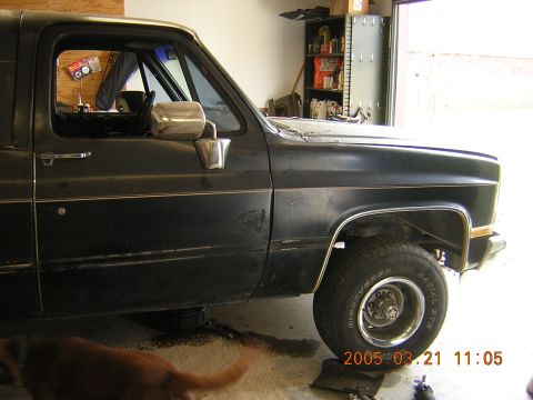 1986 Chevrolet Blazer - A black 1986 Chevrolet Blazer is shown from the front quarter panel to the door, parked in a garage.