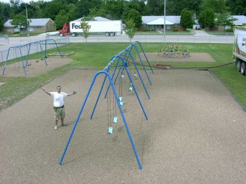1999 Jeep Grand Cherokee - A man stands in a playground with swings and a dome climber in the background.