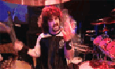 1986 Ford Bronco - A musician performs on a drum kit and tambourine during a live concert.