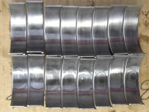 1997 Ford Taurus - A collection of used rod bearings, likely removed from an engine during maintenance or repair.