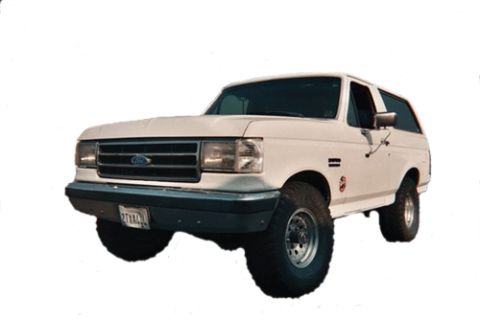 1990 Ford Bronco - white full-size Ford Bronco with a chrome grille and oval Ford badge, isolated on a plain white background.