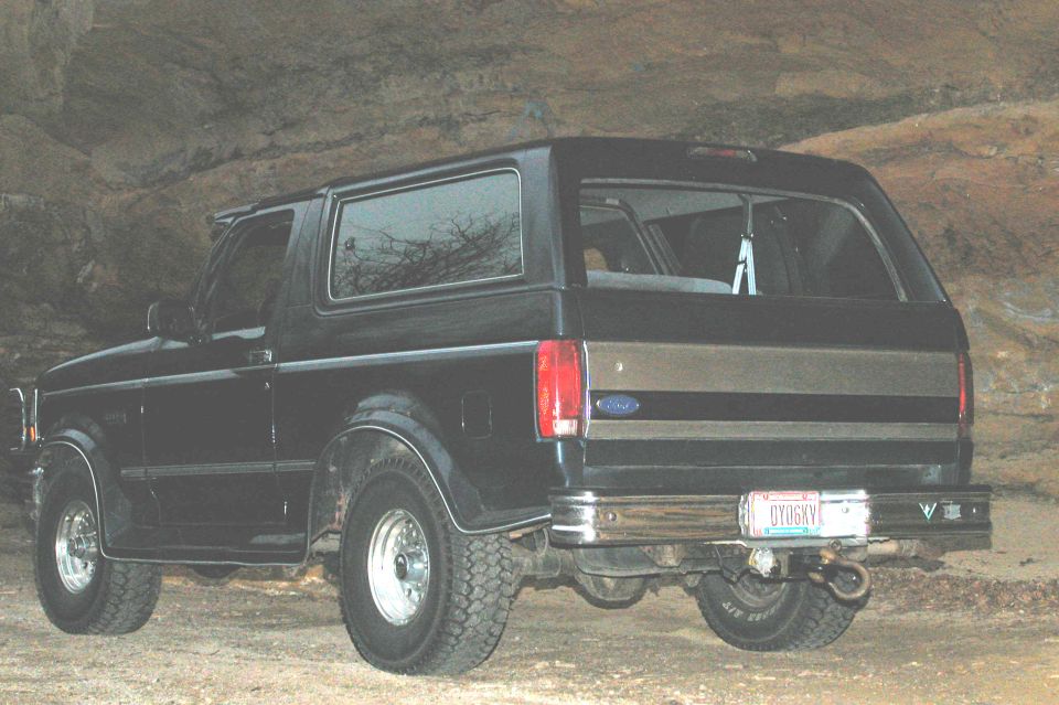 Black Ford Bronco from rear, with a two-tone stripe on the tailgate and a license plate reading GY06KV