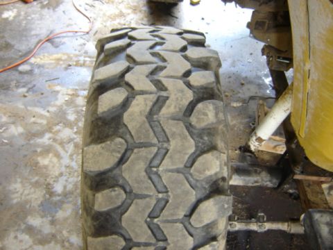 1989 Ford Bronco - A close-up view of a heavy-duty off-road tire on a vehicle's suspension.