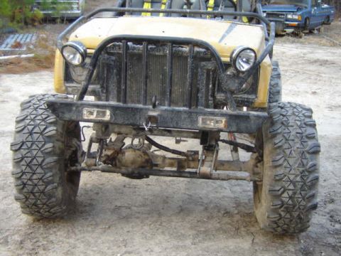 1989 Ford Bronco - This heavily modified buggy has oversized tires and a custom front bumper, with another vehicle in the background.