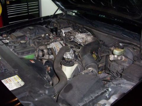2000 Ford Crown Victoria - The engine bay of a vehicle is shown, with a SuperMotors logo in the lower right corner.