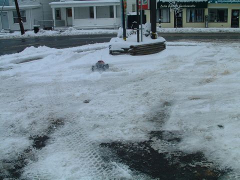 1994 Ford Bronco - A remote-controlled car navigates a snowy landscape, kicking up snow as it goes.