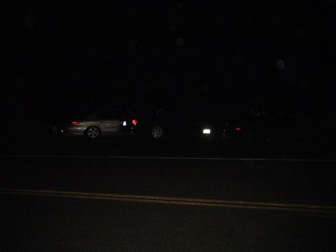 1993 Ford Taurus - Two vehicles are visible side-by-side on a dark road at night.