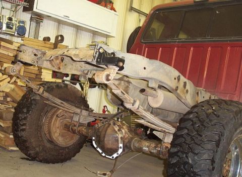 1986 Ford Ranger - The rear suspension and axle assembly of a truck are visible, with leaf springs supporting the frame.