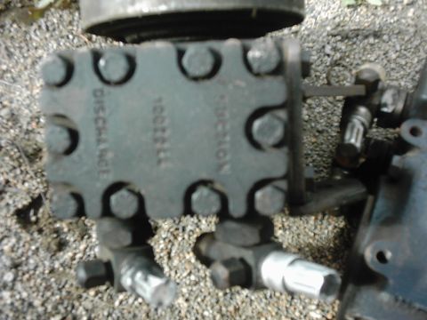 1978 Ford Bronco - Hydraulic pump part with visible 'DISCHARGE' and 'SUCTION' markings.