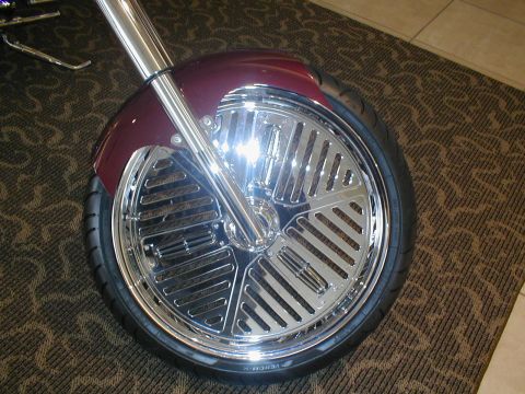 1979 Ford Bronco - A custom motorcycle's front wheel and fender are shown in detail, chrome accents and a deep red paint job.
