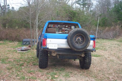 1987 Ford Bronco - This 1987 Ford Bronco is parked outdoors with a spare tire on the rear and a license plate that reads 'BYON ASF'.