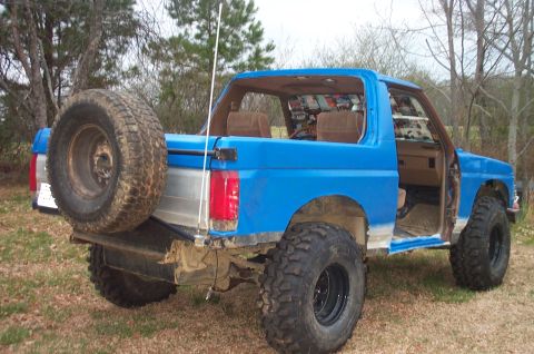 1987 Ford Bronco - This blue Ford Bronco appears to be from the early 1980s, not a 1987 model, with significant modifications.