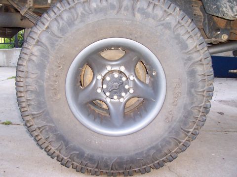 1994 Ford F-150 - A close-up view of a truck's wheel and tire, showing the tread pattern and rim.