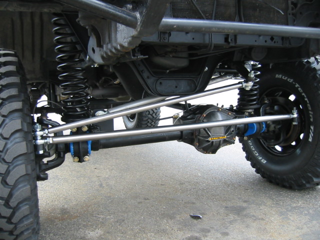 Underside of lifted Ford TTB front axle with Dynatrac cover, crossover steering and BFG mud tires