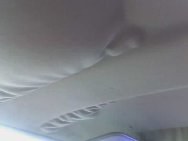Interior ceiling with visible water stains and sagging fabric