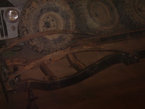 1992 Ford Bronco - The chassis and tires of a Jeep CJ-6 are visible in this image.