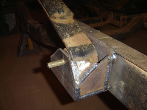 1992 Ford Bronco - Welding work on a vehicle's frame, focusing on a custom bracket and suspension component.