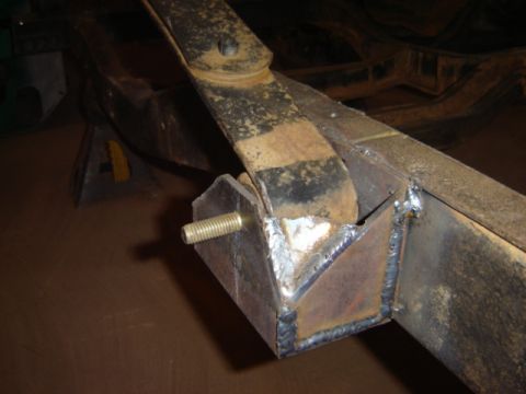 1992 Ford Bronco - Close-up of a modified vehicle frame component, showing welding and a leaf spring attachment point.