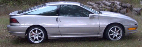 1990 Ford Probe - Side view of a silver 1990 Ford Probe coupe with a rear spoiler.