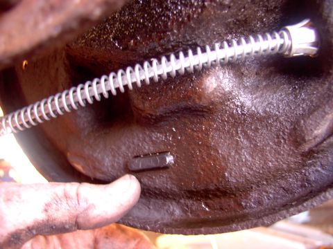 1986 Ford Bronco - After you've remounted the new wheel cylinder and washed the fluid off the backing plate, just slip the new E-cables in. The small rubber p…