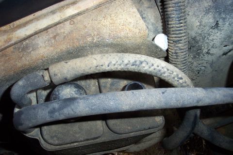 1988 Ford Bronco - Engine bay components and hoses, showing wear and dirt.