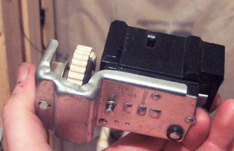 1985 Ford LTD Crown Victoria - A close-up view of a headlight dimmer switch, held in a hand.