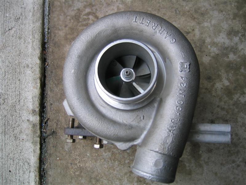Garrett turbocharger on concrete, compressor wheel and 'A/R .60' casting visible