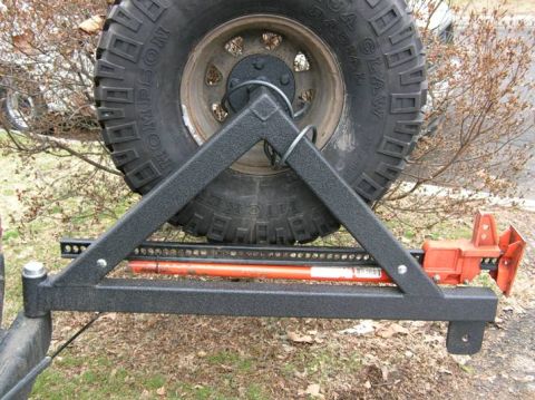 1988 Ford Bronco - Drilled through the tire carrier and installed two 1/2"x4" carriage bolts and secured them with large washers,lock washers and nuts.