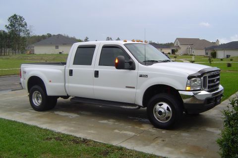 2003 Ford F-350 - This white 2003 Ford F-350 Super Duty pickup truck is shown from a three-quarter front angle.
