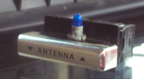 1985 Ford LTD Crown Victoria - Close-up of an antenna control button, a blue indicator light and text.