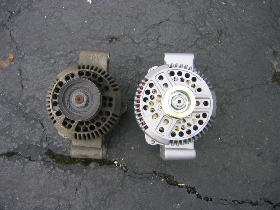 Here you can see the old and the new.  The new one is a direct bolt in replacement, although it is a bit “stouter” as the man on the phone told me.  The fact that it was bigger caused no complications on installation.   The new one is from Motor City Remain, $220.00 with shipping, I didn’t know it when I took this pic but I will have to switch the pulleys.  (The guy I ordered it from warned me that the one they send was small, and for me it was too small.)