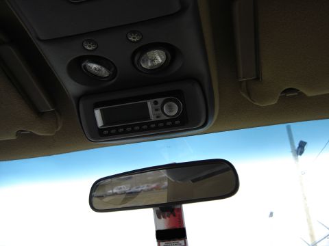 1995 Ford Bronco - Interior shot looking up at a gray overhead console set into a tan headliner, with two round map lamps and their switches above an aftermar…