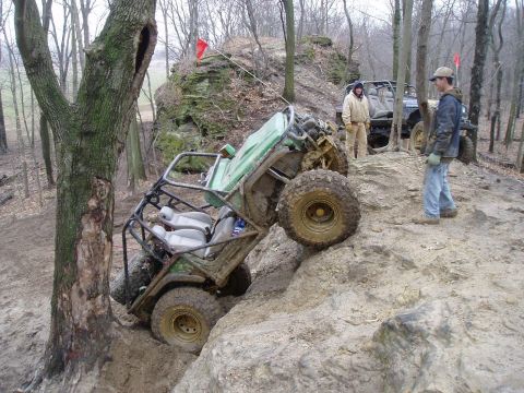 1992 Ford Bronco - Two off-road vehicles are on a rocky trail, one stuck at an angle.