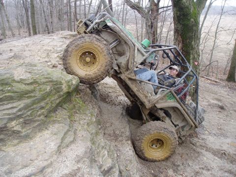 1992 Ford Bronco - Off-road buggy navigating a challenging muddy and rocky terrain.