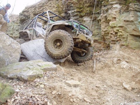 1992 Ford Bronco - A modified off-road vehicle navigates a challenging rocky incline.