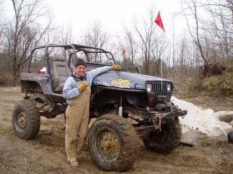 1992 Ford Bronco - Modified Jeep Wrangler with a man posing next to it on an off-road trail.