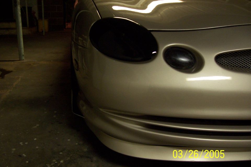 1998 Mercury Sable front end with blacked-out headlights and grille