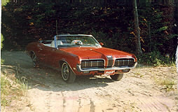 1970 Mercury Cougar - This 1970 Mercury Cougar convertible is seen from a 3/4 front angle, with its grille clearly visible.