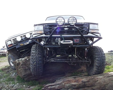 1993 Ford Bronco - Two Ford Broncos navigate a rocky terrain, their off-road capabilities.