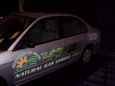 1989 Ford Bronco - This Honda Civic sedan is branded as a natural gas vehicle with environmental graphics on its side.