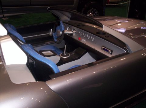1989 Ford Bronco - Interior view of a car with distinctive blue seats and a modern dashboard design.