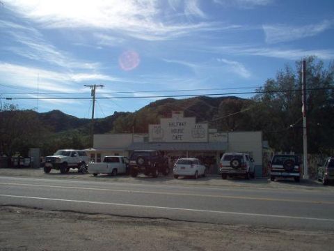 1988 Ford Bronco - A row of vehicles are parked outside the Halfway House Cafe on a sunny day.