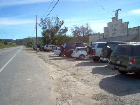 1988 Ford Bronco - Several vehicles are parked along the side of the road next to the Halfway House Cafe.